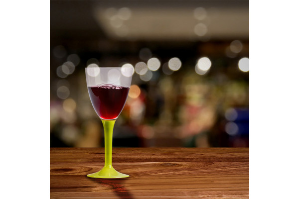 Verre en vin en plastique vert anis, vert clair rempli sur décor